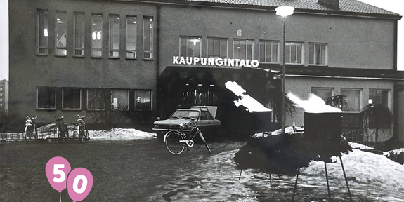 Raision kaupungintalo 1970-luvulla. Mustavalkoisessa valokuvassa vasemmassa reunassa kaksi pinkkiä ilmapalloja ja teksti Raisio.